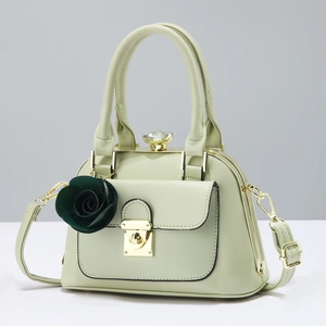 Elegant light green semi-circle handbag with gold buckle and rose charm detail