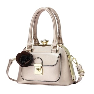 Champagne gold luxury handbag with crystal clasp and detachable strap on white background