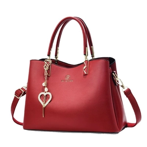 Elegant red litchi texture leather tote bag with gold hardware and heart pendant