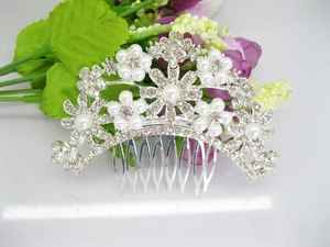 Close-up of bridal hair comb featuring silver flowers with faux pearls and rhinestones