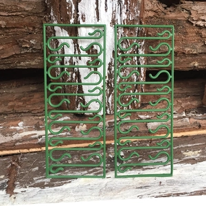 Detailed view of green S-shaped plastic hooks for hanging Christmas tree ornaments