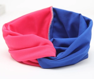 Detail eines rosa-marineblau geknoteten Stirnbands aus weichem, elastischem Strick