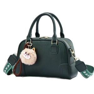 Elegant dark green lychee leather handbag with cute cat pendant and canvas strap