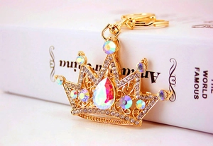 Detailed view of a golden crown keychain featuring sparkling teardrop crystals and gold plating