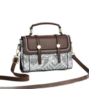 Brown leather and retro wave pattern fabric handbag with a golden metal buckle