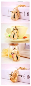 Close-up of pearl-beaded frog keychain with green zircon eyes and gold alloy ring