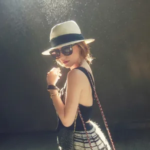 Summer wide brim white Panama straw hat with black ribbon and chic sunglasses