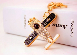 Macro detail of helicopter keychain with clear rhinestones and black enamel accents
