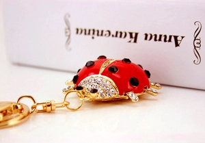 Macro shot of colorful ladybug keychain with red enamel and sparkling crystal details