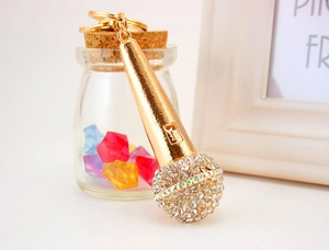 Detail of microphone keychain with gold plating and sparkling crystal rhinestones