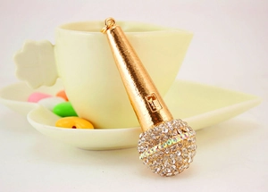 Detail shot of a golden microphone keychain with sparkling rhinestones in a lifestyle setting