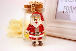Detail of Santa Claus keychain with rhinestones and enamel finish in a gift setting