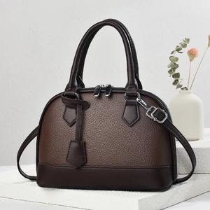 Detailed view of dark brown pebbled leather texture and silver zipper of the Boston bag
