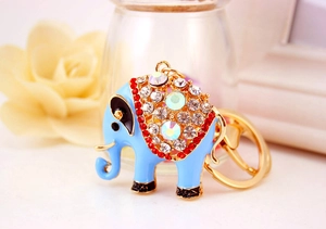 Close-up van de gouden olifant sleutelhanger met blauw email en glinsterende strassteentjes