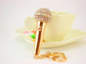 Detailed close-up of golden microphone keychain with sparkling crystal rhinestones
