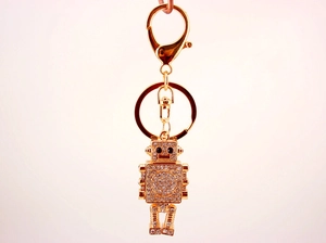 Detailed view of a golden robot keychain with sparkling rhinestones and spring clasp