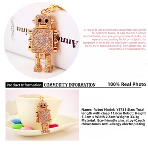 Close-up of golden robot keychain with sparkling rhinestones and metal link detail