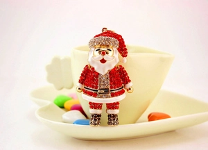 Close-up of Santa Claus keychain with vibrant red and white crystals on gold frame