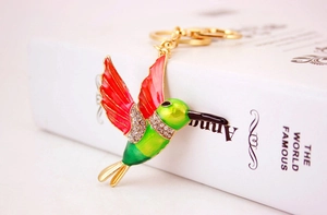 Detail of creative hummingbird keychain with red enamel finish and sparkling rhinestones