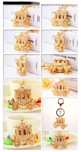 Macro view of golden hollow carriage keychain with rhinestones and lobster clasp details
