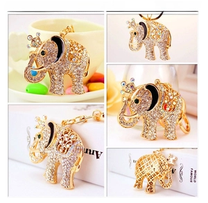 Detail of a golden elephant keychain with sparkling rhinestones and a crown motif