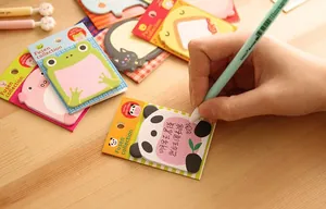 Cute cartoon animal sticky notes on wooden desk with handwriting showing daily message use