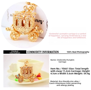 Macro detail of golden pumpkin carriage keychain with inlaid rhinestones and dimensions