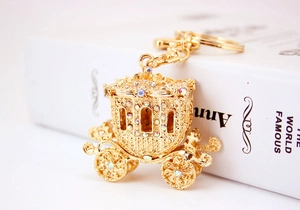Close-up of golden pumpkin carriage keychain with sparkling rhinestone detailing