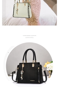 Detail of crocodile embossed texture on a crossbody bag with a cute rabbit pearl charm