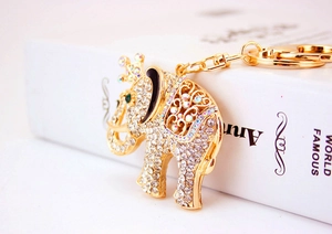 Close-up of sparkling rhinestone elephant keychain with crown and green eye detail