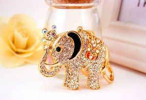 Macro shot of golden elephant keychain with sparkling rhinestones and crown detail