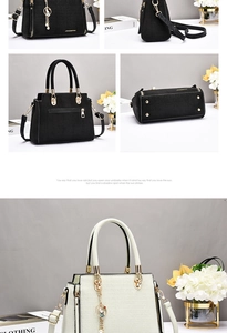 Detail view of crocodile pattern handbag with metal zipper and adjustable strap