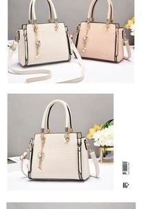Detail of elegant crocodile texture handbags in beige and pink with gold metal handles