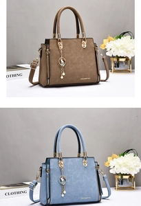 Detail view of crocodile pattern faux leather handbags with metal tassels and round handles