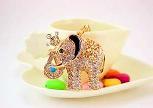 Close-up of golden elephant keychain with sparkling rhinestones and crown detail