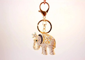 Close-up of golden elephant keychain with sparkling rhinestones and a crown detail