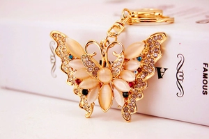 Detail of butterfly keychain featuring beige opal stones and sparkling rhinestones