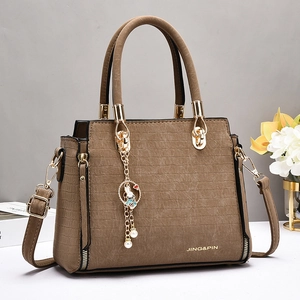 Brown faux crocodile leather shoulder bag with top handle and rabbit charm pendant