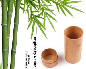 Detail of cylindrical bamboo storage tube with natural wood grain texture and lid