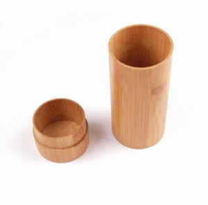 Detailed top view showing natural wood grain texture of a cylindrical bamboo eyewear case