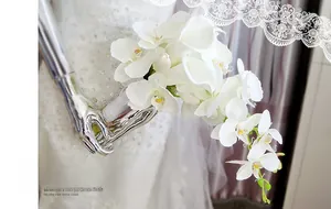Detail of white calla lily bridal bouquet with silk ribbon and teardrop floral design