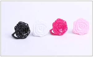 Detailed row of rose-shaped hair clips in black, white, rose red, and pink colors