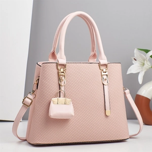 Elegant macaron pink tote bag with woven texture and gold hardware detailing