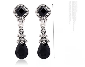 Detail of silver drop earrings with black stones and 40mm length measurements