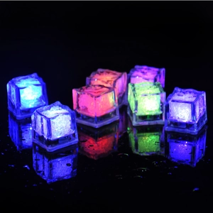Group of colorful LED glowing ice cubes with water droplet reflections on dark surface