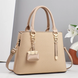 Elegant beige straw texture handbag with leather handles and gold-tone hardware detail