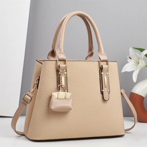 Elegant beige woven texture handbag with gold metal accents and white lily background
