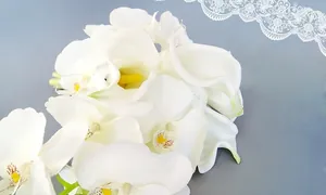 Detail of white calla lily and orchid bridal bouquet with realistic yellow stamens