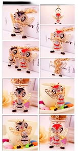 Detail of bee keychain featuring clear rhinestones and colorful enamel on metal base