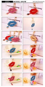 Detail of crystal rhinestone red lip and lipstick keychain charms in multiple colors